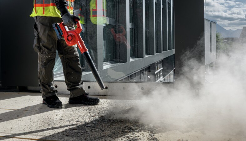 Worker cleaning the jobsite floor using Hilti NBL 4-22 cordless blower