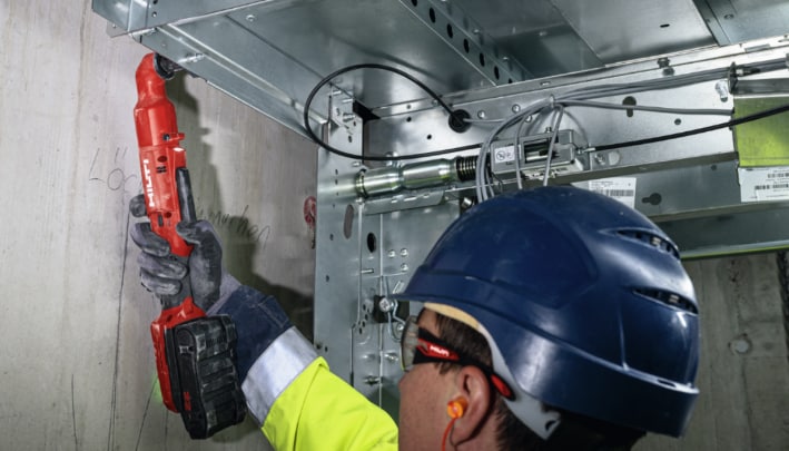 Worker checking the anchor installation status on Hilti SIW 6AT-22